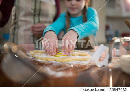 Mother and daughter preparing cookies in kitchen 36847982