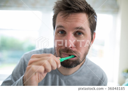 Man brushing teeth in the bathroom 36848185