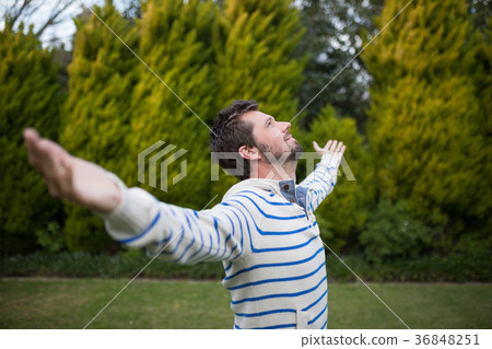 Man standing with arms wide open Man standing with arms wide open 36848251