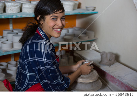 Portrait of female potter molding a clay 36848615