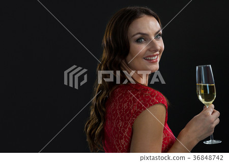 Smiling woman holding glass of champagne 36848742