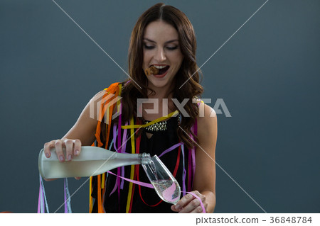 Woman pouring champagne into glass 36848784