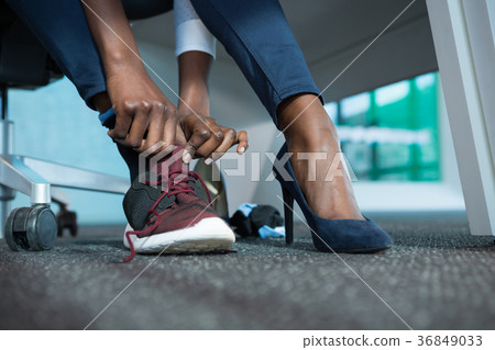 Executive wearing shoes in futuristic office Executive wearing shoes in futuristic office 36849033