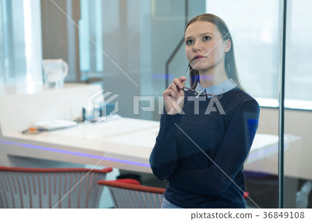 Female executive looking at digital screen 36849108