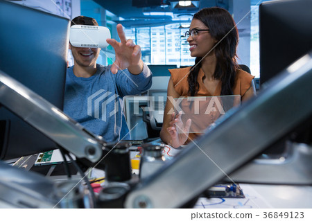 Executives using virtual reality headset at desk 36849123