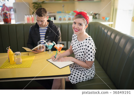 Couple looking at menu in restaurant 36849191