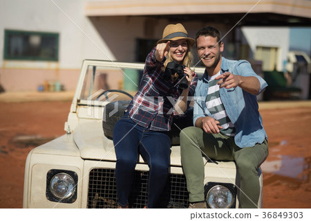 Couple sitting together on a car 36849303
