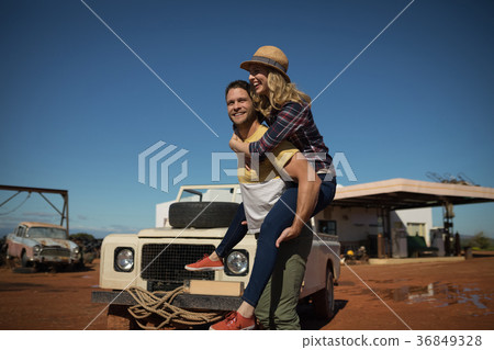 Man giving a piggyback ride to woman Man giving a piggyback ride to woman 36849328
