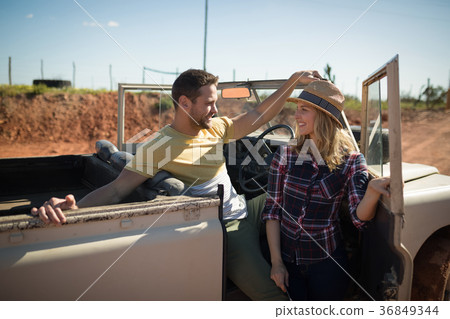 Couple relaxing in their car on a sunny day Couple relaxing in their car on a sunny day 36849344
