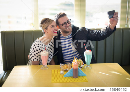 Couple taking selfie with mobile phone Couple taking selfie with mobile phone 36849462