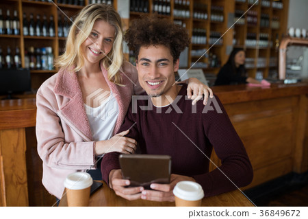 Couple using digital tablet in bar 36849672