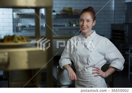 Female chef standing in the kitchen 36850002