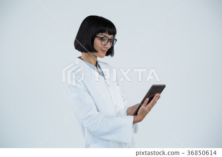 Doctor using digital tablet against white background Doctor using digital tablet against white background 36850614