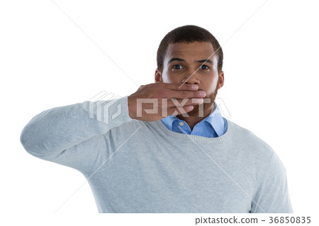Male executive covering his mouth with hand Male executive covering his mouth with hand 36850835