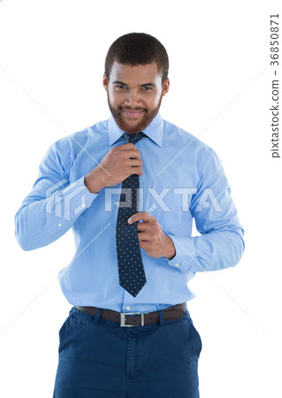 Businessman adjusting his tie 36850871