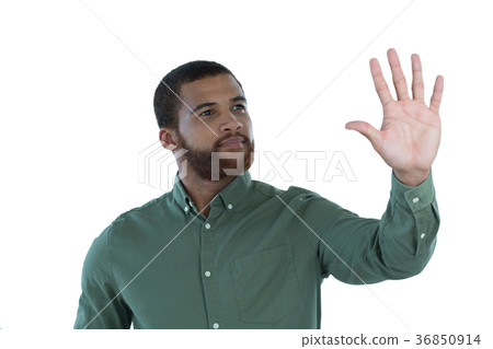 Male executive pretending to use an invisible screen Male executive pretending to use an invisible screen 36850914