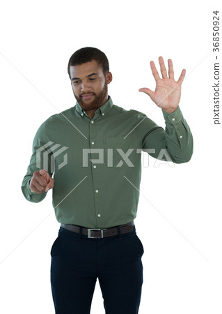 Male executive pretending to use an invisible screen 36850924