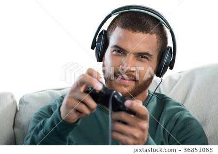 Man playing video game against white background 36851068