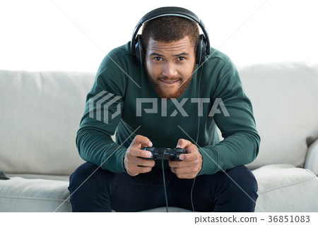 Man playing video game against white background Man playing video game against white background 36851083
