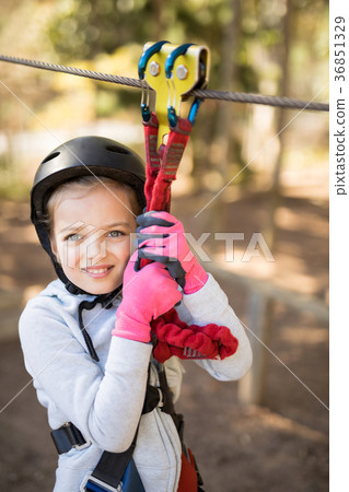 Cute girl enjoying zip line adventure on sunny day 36851329