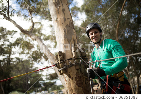 Man attaching carabiner to rope 36851388