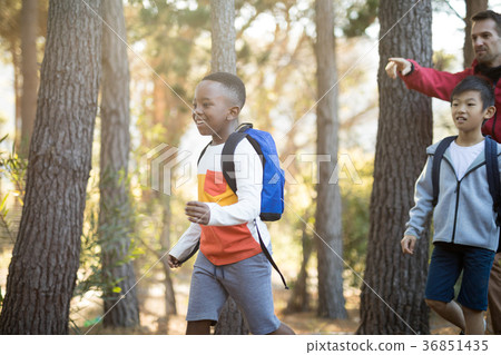 Teacher interacting with kids in park Teacher interacting with kids in park 36851435