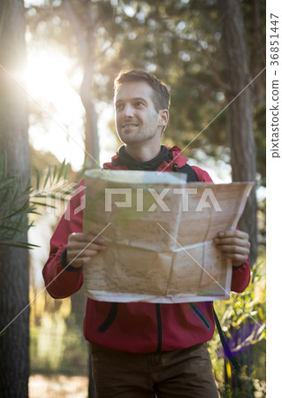 Man holding map in forest Man holding map in forest 36851447