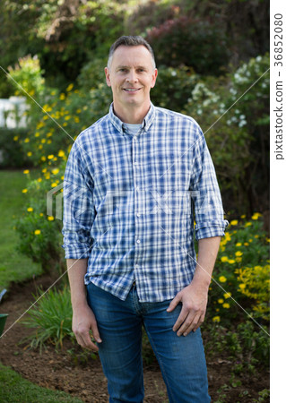 Smiling man standing in garden 36852080