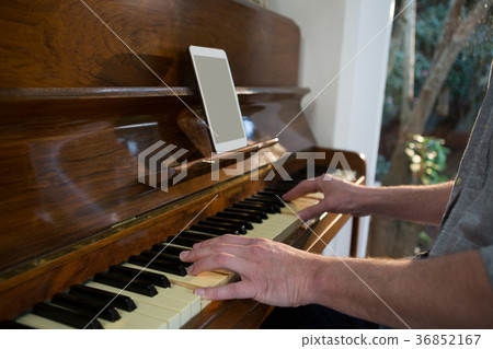 Man playing piano at home 36852167