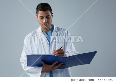 Doctor writing a reports in the file Doctor writing a reports in the file 36852260