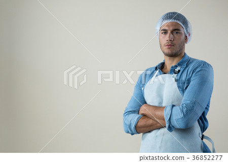 Confident waiter standing with his hands crossed Confident waiter standing with his hands crossed 36852277