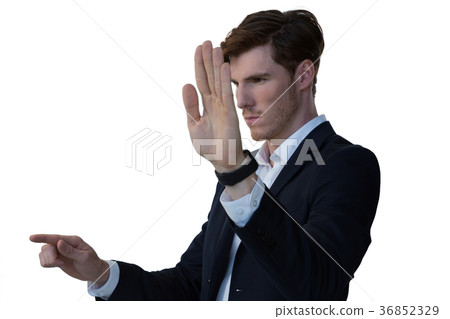 Businessman pretending to use an invisible screen Businessman pretending to use an invisible screen 36852329
