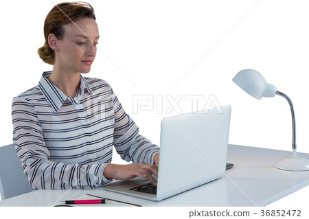 Female executive using laptop at desk 36852472