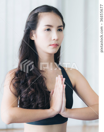 Woman practicing yoga pose in gym Woman practicing yoga pose in gym 36855677