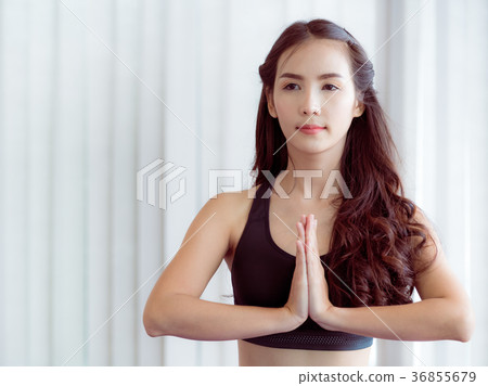 Woman practicing yoga pose in gym 36855679