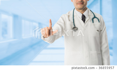 Male doctor pointing finger at copy space. Male doctor pointing finger at copy space. 36855957