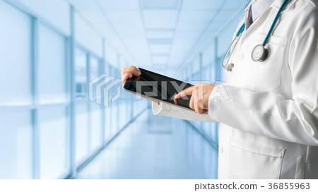 Male doctor using tablet computer. Male doctor using tablet computer. 36855963