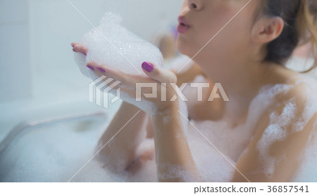 Woman enjoying bath time 36857541