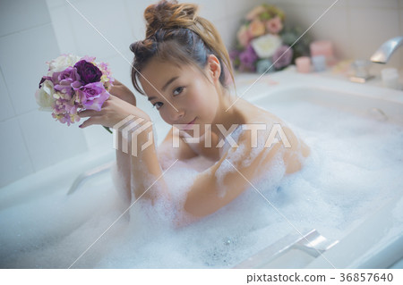 Woman enjoying bath time Woman enjoying bath time 36857640
