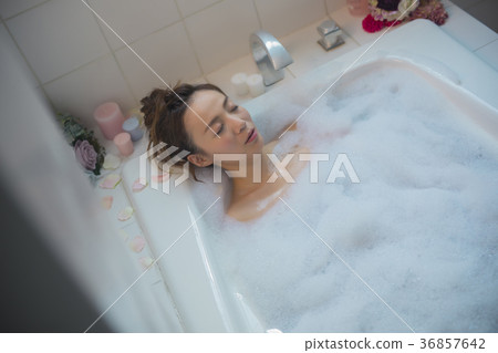 Woman enjoying bath time Woman enjoying bath time 36857642