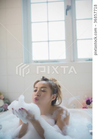 Woman enjoying bath time 36857718