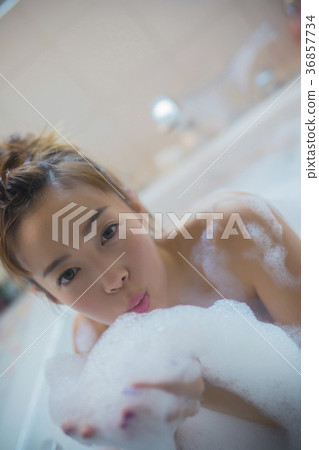 Woman enjoying bath time 36857734