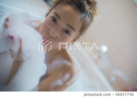 Woman enjoying bath time 36857736