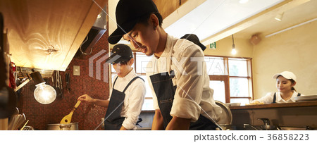 Staff cooking in a cafe kitchen Staff cooking in a cafe kitchen 36858223
