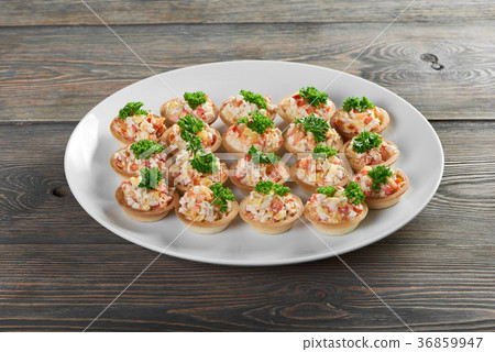 Tartlets served with a vegetable salad and parsley 36859947