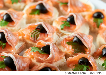 Little canapees with salmon and black olives 36859950