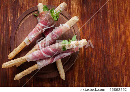 Italian grissini with ham prosciutto 36862262