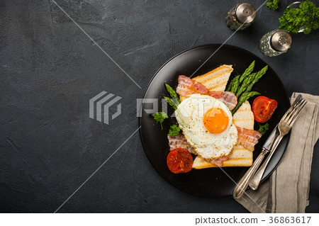 Fried egg with bread toast and asparagus Fried egg with bread toast and asparagus 36863617