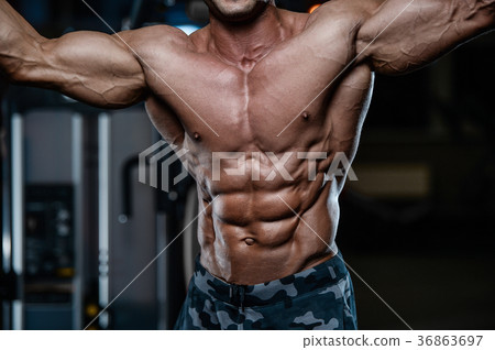 Brutal strong bodybuilder athletic men pumping up muscles with d Brutal strong bodybuilder athletic men pumping up muscles with d 36863697