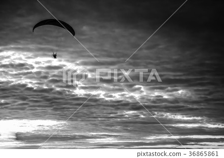 Motorized paraglider flying up high on the sky 36865861